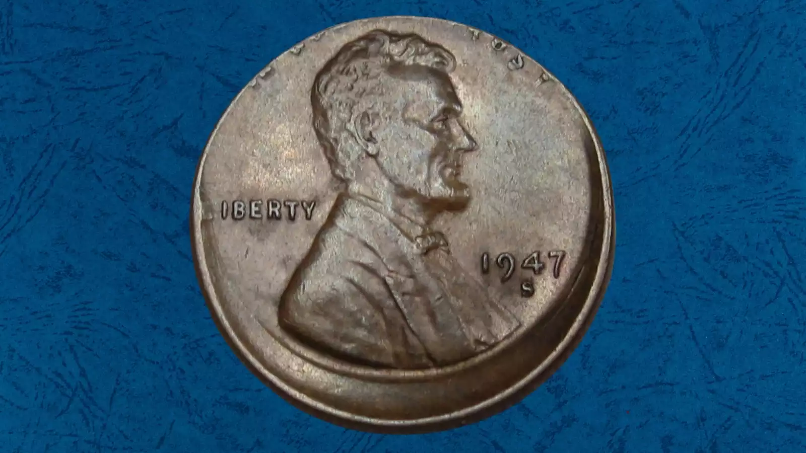 1947 wheat penny off-center strike error showing partial design and crescent-shaped blank area with date still visible